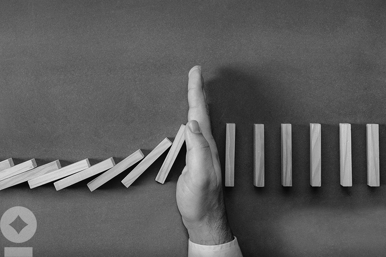 American flag flying over government building in city, blue sky and clouds Chain Reaction In Business Concept, Businessman Intervening Dominoes Toppling