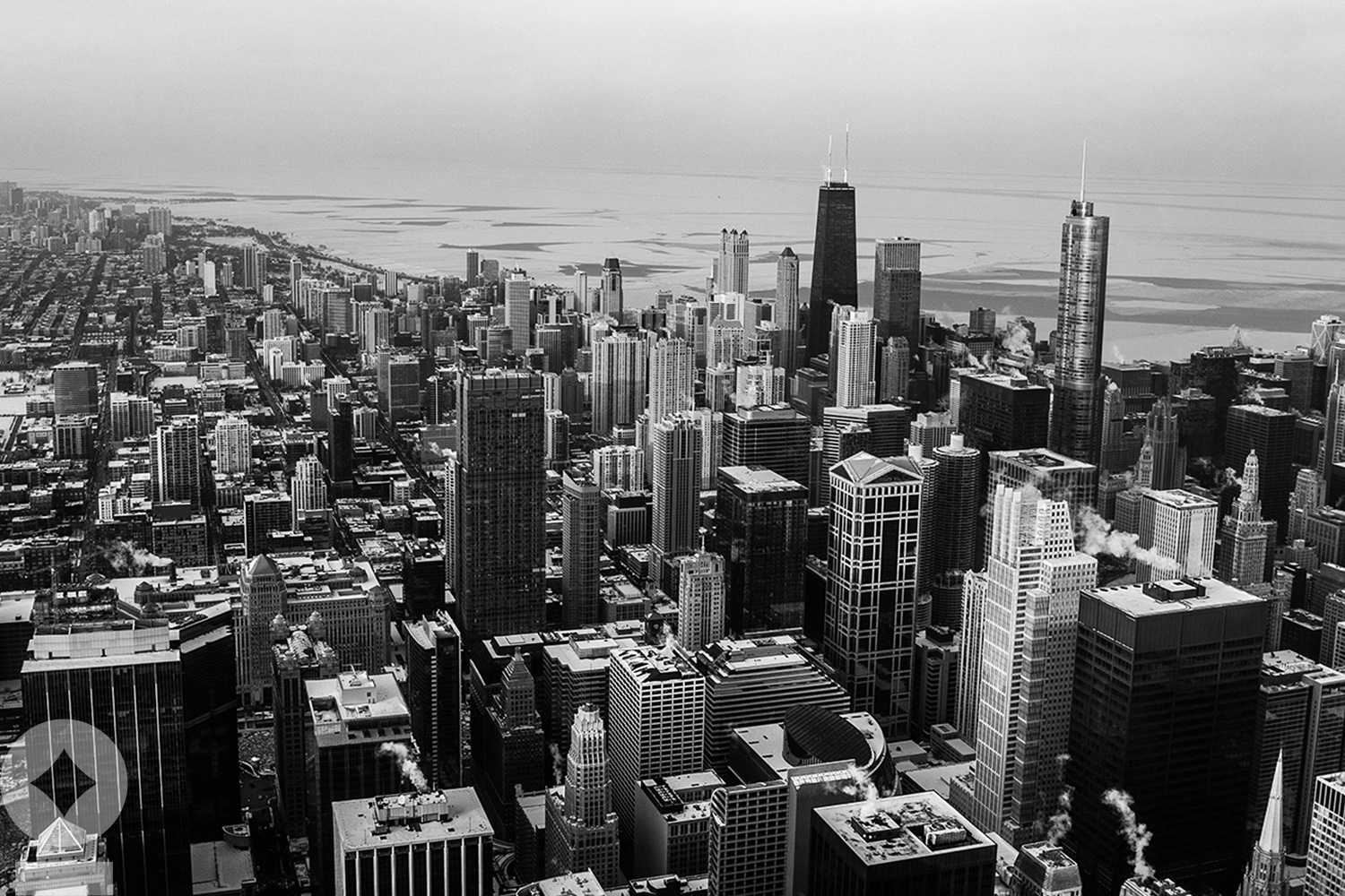 American flag flying over government building in city, blue sky and clouds