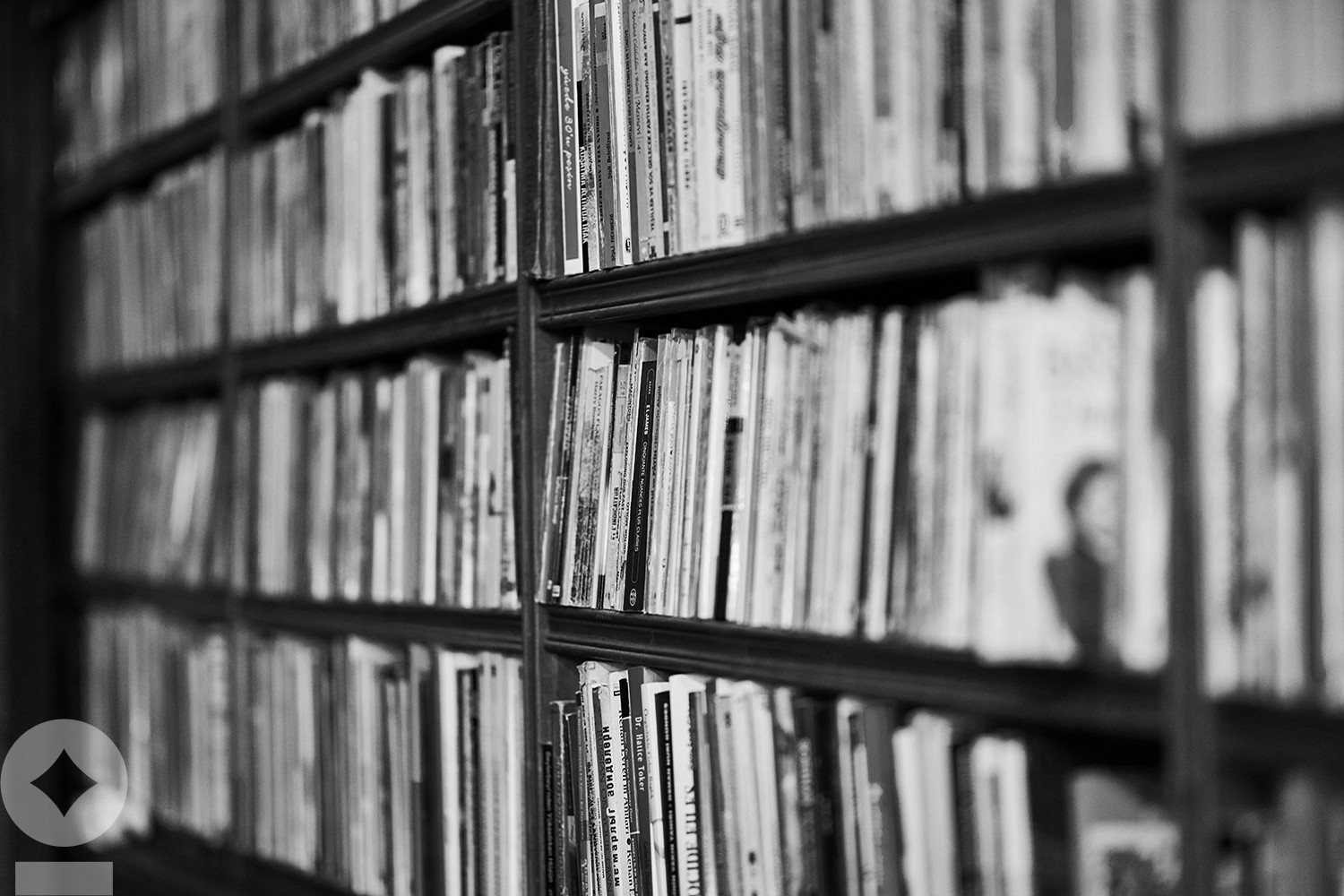 American flag flying over government building in city, blue sky and clouds