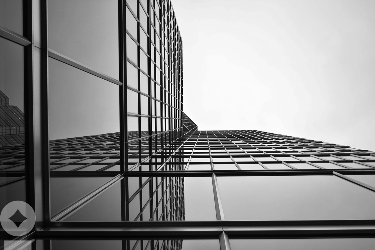 American flag flying over government building in city, blue sky and clouds