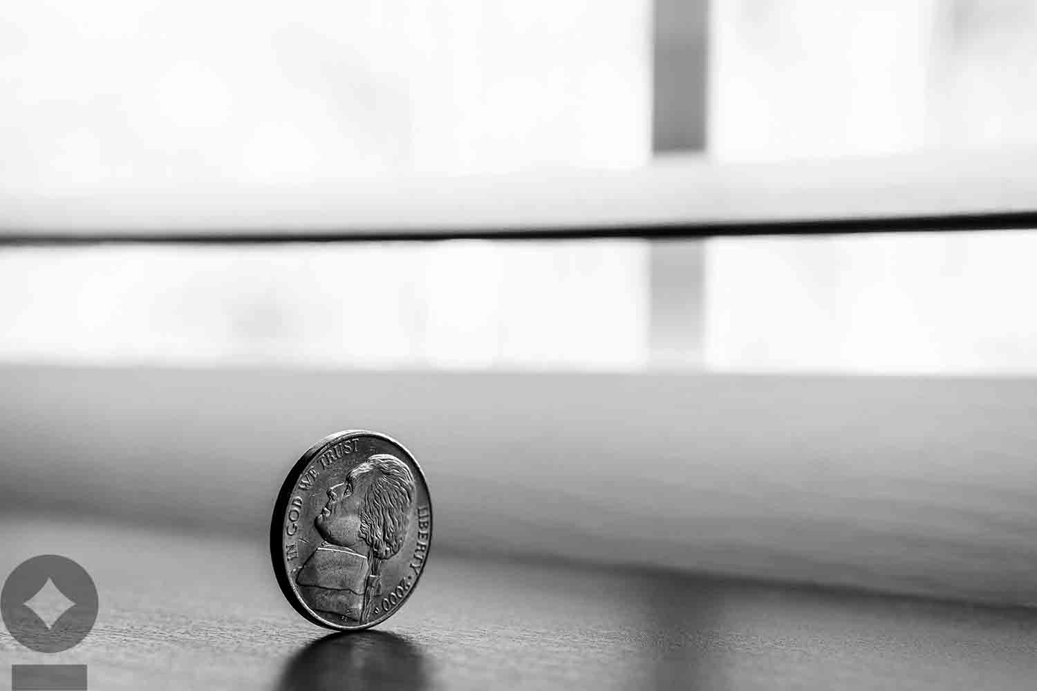 American flag flying over government building in city, blue sky and clouds