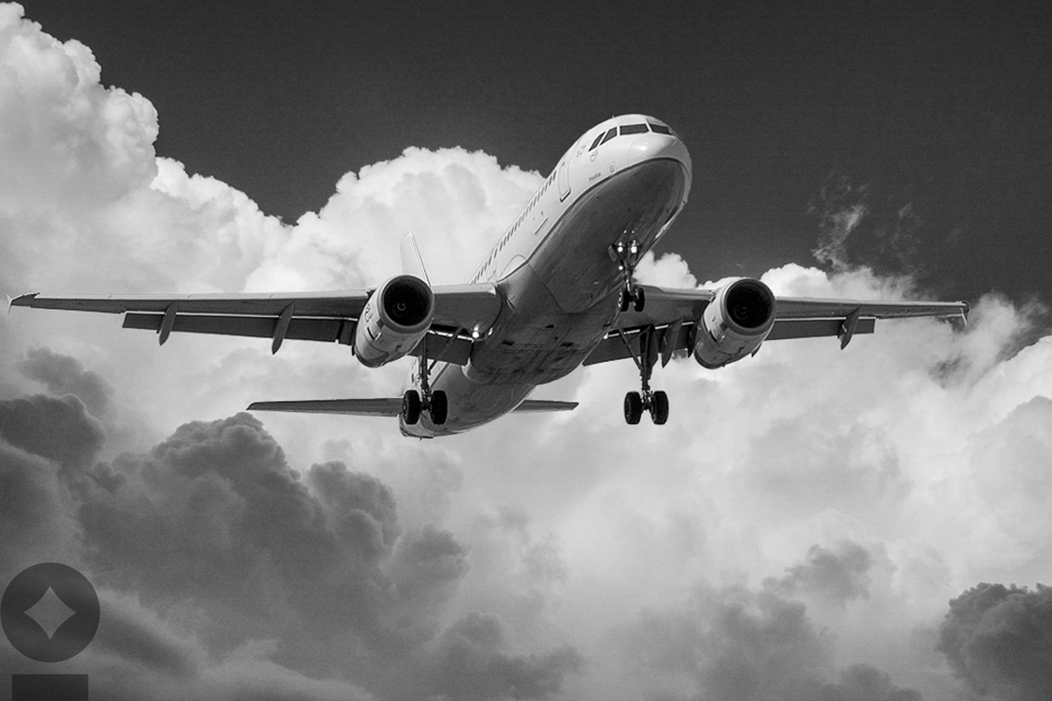American flag flying over government building in city, blue sky and clouds