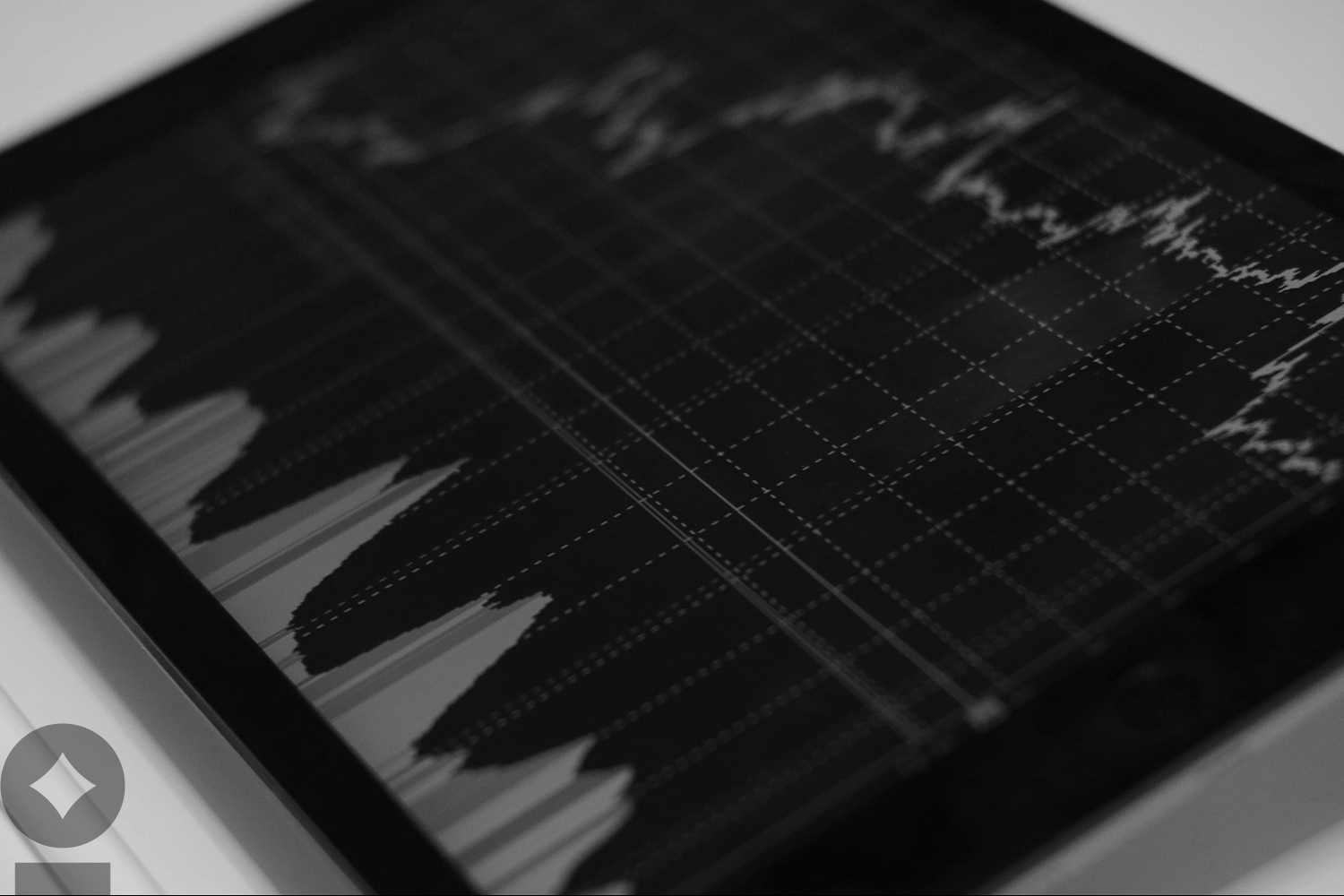 American flag flying over government building in city, blue sky and clouds